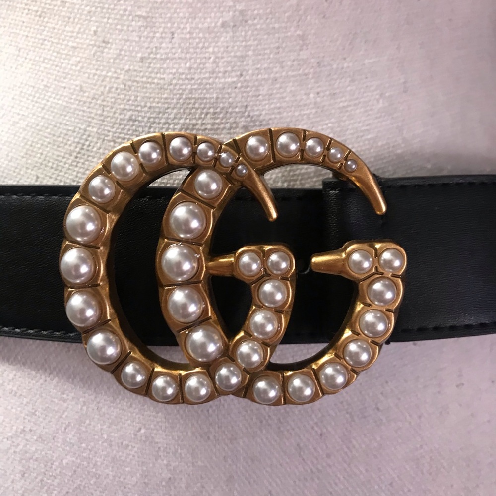 GG black leather belt. Gold and Pearl buckle
